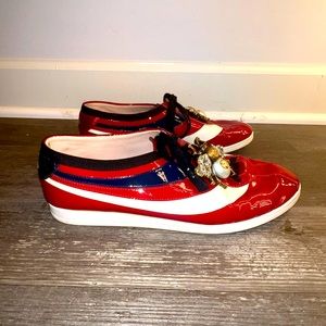 Cool blue and red tennis shoes with bee on top as jewels